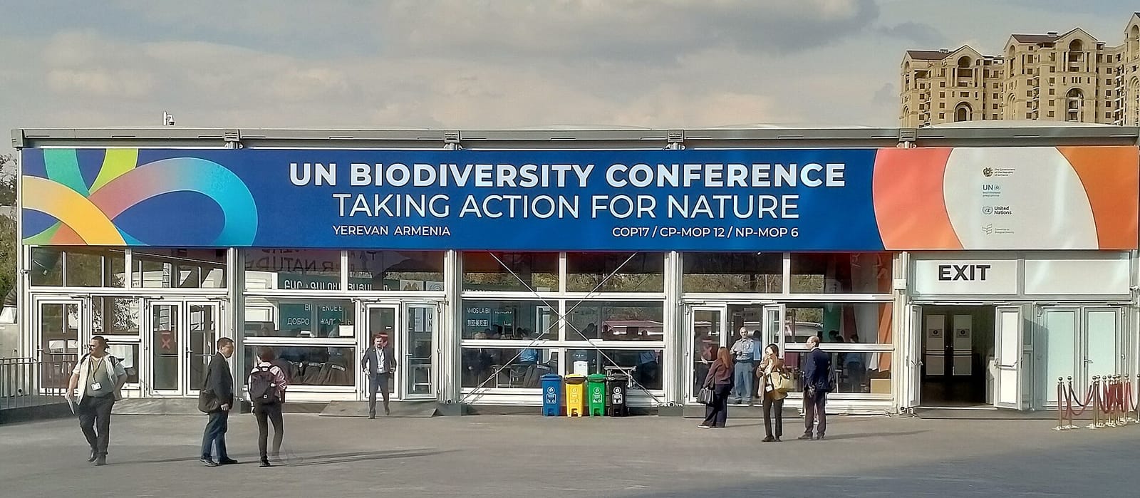 Entrée du centre de conférence avec une grande bannière bleue « UN Biodiversity Conference, Taking Action for Nature ».